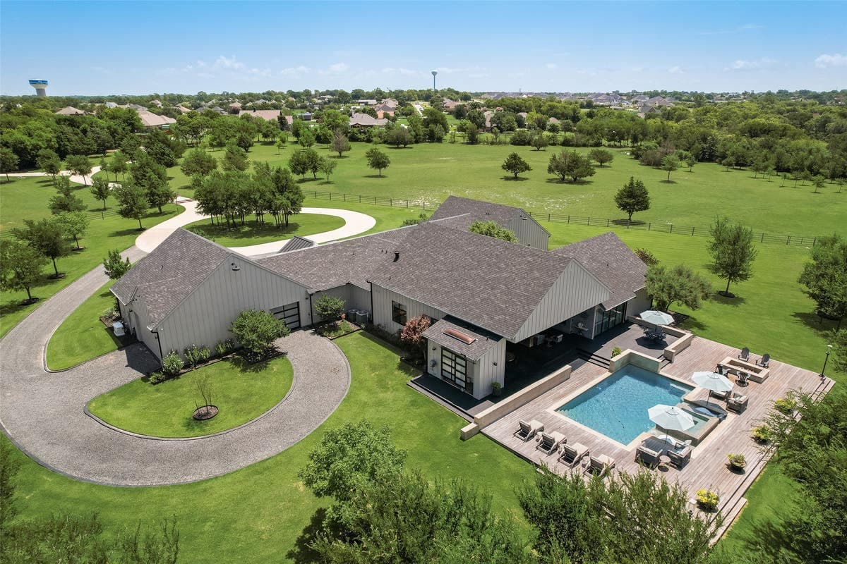 Aerial view of the estate showing the home, pool, and surrounding acreage